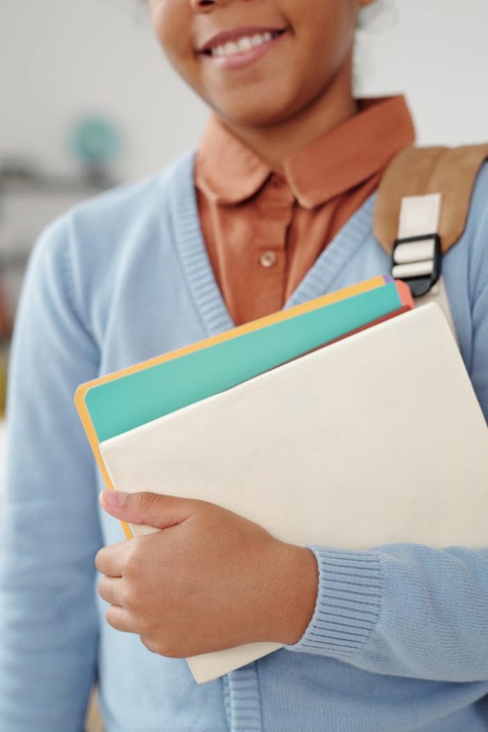 African American student with textbooks, ready for school. Ideal for educational themes.